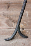 Black metal Fire Stick Fire Poker on a wooden floor