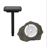 Solar-powered outdoor light fixture with stone-like design on a white background
