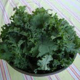 Bowl of green kale vegetables on a striped tablecloth KALE Seeds, Premier