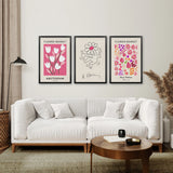 Living room with a white sofa, wooden coffee table, and Keith Haring & Matisse Pink Set of 3 Prints
