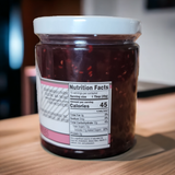 Jar of jam with a nutrition facts label on a wooden surface