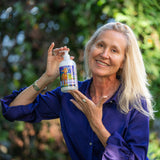 Woman holding a bottle of LIQUID SOAP - LAVENDER GOATS MILK 16 oz.