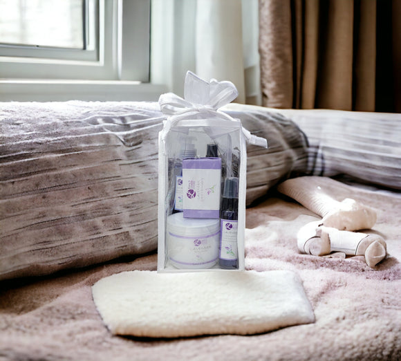 Gift set with skincare products on a bed
