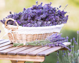 Basket of lavender flowers on a wooden table with a blurred natural background