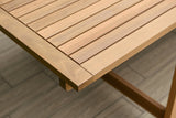 Close-up of a wooden table with a blurred background