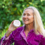 Woman holding a jar of THE LILY GARDEN 8 oz. ~ FARM TO TABLE HAND CREAM