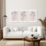 Living room with a white sofa, wooden coffee table, and Pink Wall Art Set Of 3 Botanical Modern Decor