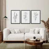 Modern living room with a white sofa, wooden coffee table, and Boho Botanical Art Prints | Set of 3 Green Leaves
