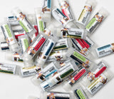 Multiple tubes of Appalachian Goat Creamery lip balm on a white background