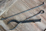 Black metal fireplace tools on a wooden floor Mini Log Grabber & Fire Poker Set