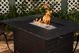 Fire pit table with flames on a patio