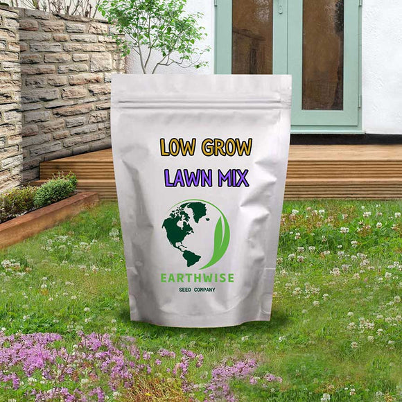 Bag of Earthwise Low Grow Lawn Mix on a grassy lawn with a stone wall and garden in the background