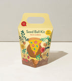 Seed ball kit packaging with pizza design on a light background