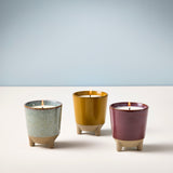 Three ceramic candles in different colors on a light surface with a light blue background Glow & Grow Kits