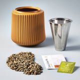 Ceramic pot, metal cup, plant fertilizer, and potting mix on a gray background Flower Grow Kit