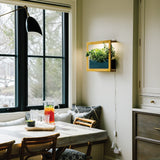 Dining area with a large window, table set for a meal, and wall-mounted plant. Smart Standard Growframe