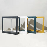 Four geometrically shaped tables in different colors on a white surface with a light gray background Smart Standard Growframe