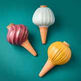 Three decorative Terracotta Watering Bulbs in different colors on a teal background