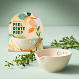Peel, Grate & Prep Dish with 'modern sprout' packaging and greenery on a light green background