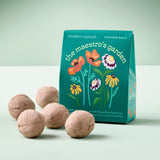 Five seed balls in front of a 'the maestro's garden' packaging on a light background Bespoke Blooms Seed Balls