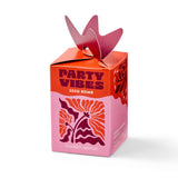 Pink and orange 'Party Vibes' seed bomb packaging with decorative elements on a white background.