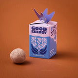 Box labeled 'Good Energy' with a purple bird decoration on an orange background Seed Bombs