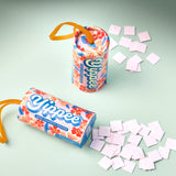 Yippee confetti popper with colorful packaging and scattered confetti on a light green background