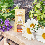 Hunny Poop wildflower seed ball packaging with flowers on a natural background