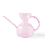 Pink watering can on a white background