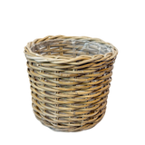 Wicker basket with a clear plastic liner on a white background