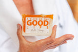 Bar of soap with 'A Slice of the Good Life' branding held by a person.