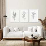 Living room with a white sofa, wooden coffee table, and Boho Botanical Art Prints | Set of 3 Green Leaves