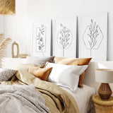 Decorative bedroom with Minimal Flower Line Art: Black White Wall Art Set pillows, and lamps.