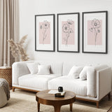 Modern living room with a white sofa, round wooden coffee table, and Pink Wall Art Set Of 3 Botanical Modern Decor