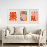 Henri Matisse Flower Market Colorful Poster on a wall above a sofa with a blanket draped over it.