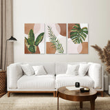 Living room with a white sofa, round wooden coffee table, and wall art with 3 Piece Terracotta Boho Wall Art. Green Tropical Leaves