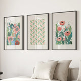Botanical Pink Poppies Wall Art Poster Decor on a wall above a sofa with pillows.