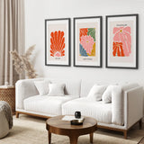 Living room with a white sofa, wooden coffee table, and abstract Henri Matisse Flower Market Colorful Poster on the wall.