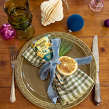 Decorative table setting with a plate, napkin, and lemon slice on a wooden table. Seed Pops - Pollinator