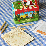 Modern Sprout Mighty Snack Garden kit on a blue checkered tablecloth with wooden cards and pencils.