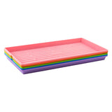 Set of colorful trays stacked on a white background
