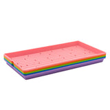 Set of colorful plastic trays stacked on a white background