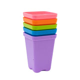 Stack of colorful plastic containers on a white background