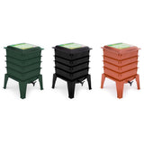 Three compost bins in green, black, and red on a white background