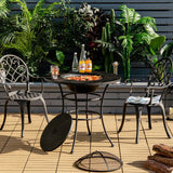 Outdoor patio setting with a table, chairs, and a grill on a wooden deck.