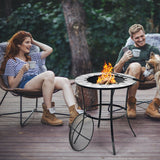 Two people sitting around a fire pit table outdoors, enjoying a warm evening. 23.5 Inches Round Fire Pit Table with Mesh Cover and Fire Poker - Color: Black