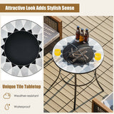 Round table with unique tile top on a patio, featuring drinks and firewood.
