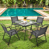Outdoor patio set with table and chairs by a pool
