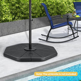 Black patio umbrella base on a patio with a rocking chair and pool in the background.