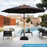 Outdoor patio setting with a large umbrella over a table by a poolside.